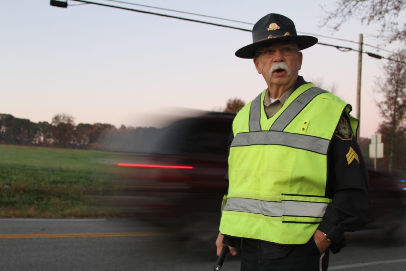Ernest Rudder is the crossing guard for Bush Middle School. At 7:45 am, he directs traffic and makes sure the children get into school safely. His day is just getting started. After his shift as a crossing guard he heads to the Laurel County Sheriffs office to go over paperwork, and run through his routine for the day. Ernest Rudder is a former school teacher, middle school principal and a current administrative Sgt. with the Laurel County Sheriff's Department. He taught high school biology, and worked in the Bush school district for a total of 31 years. Rudder is not only a Sheriff's Deputy but he's a family man, and not a single person has a bad thing to say about him. Photo by Kirsten Holliday