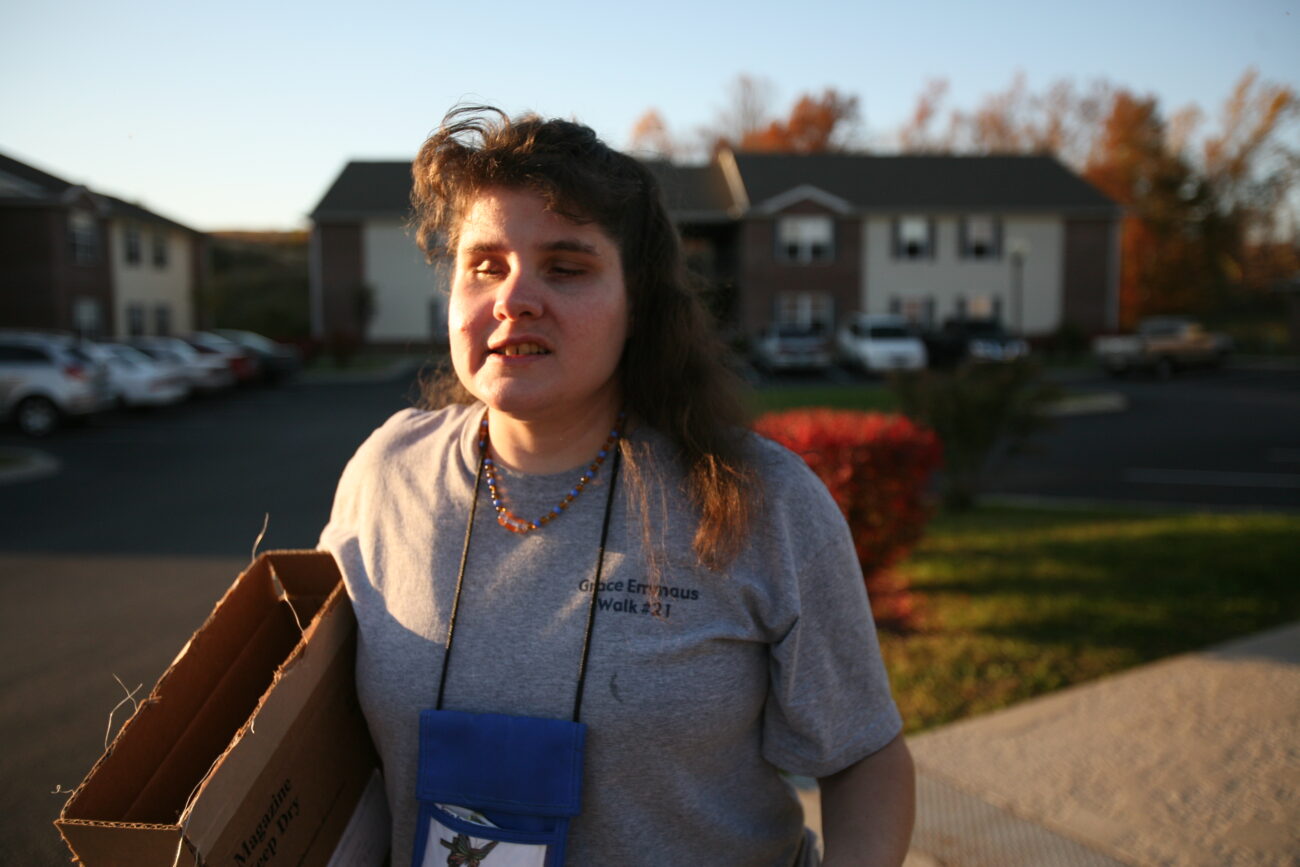 Paula Caldwell takes out the trash by herself outside her home by taking the path she's memorized from taking it out many times before. "We don't like to be defined by our disabilities," said Paula. Photo by Genevieve Adams