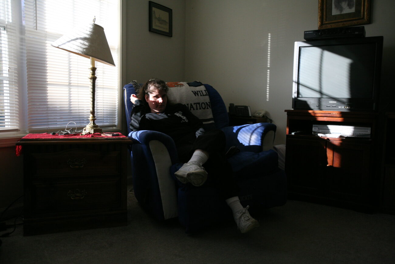 Paula Caldwell sits in her living room. This room is where the couple spends most of their time watching TV, checking e-mails and listening to the news. Photo by Genevieve Adams