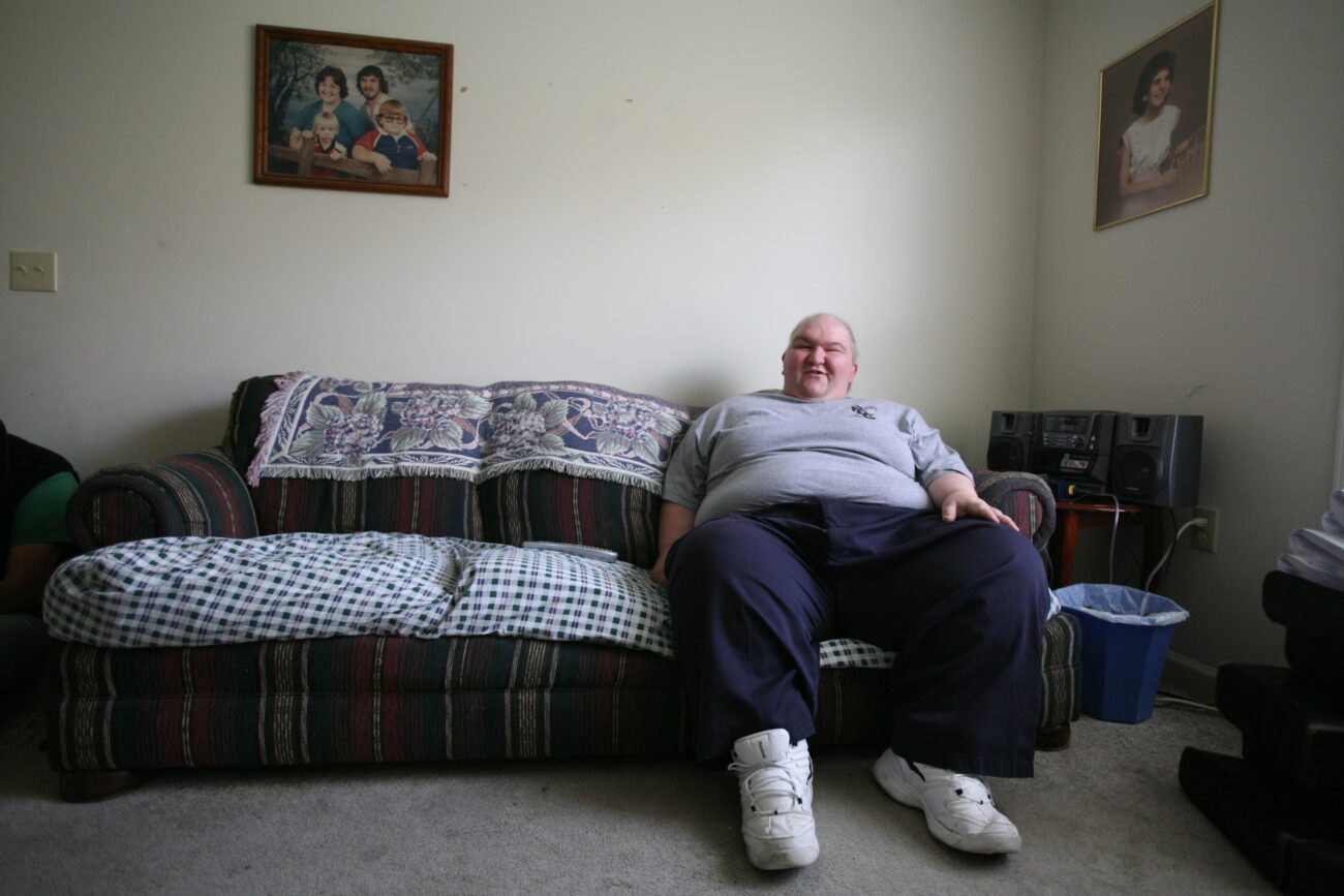 Shannon Caldwell relaxes in his living room. The far right is his designated spot on the couch. Photo by Genevieve Adams