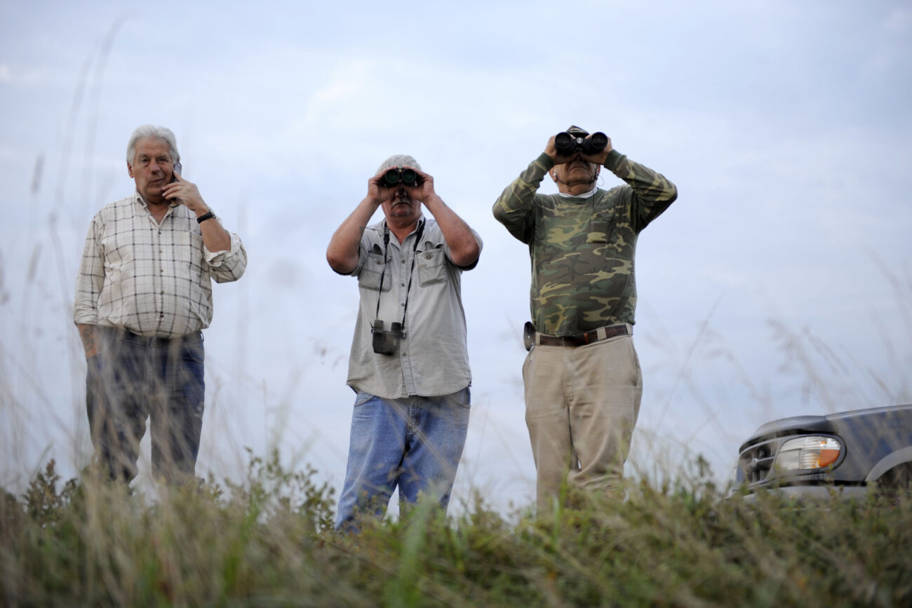 Howard Woolum, left, James Holland, center, and James Woolum scout bull elk from a ridge top in Knott County. James Woolum received an elk tag this year..