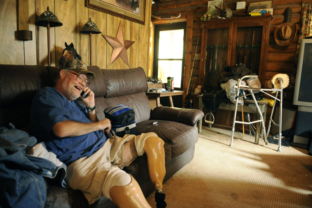 Jim laughs as he talks to his dad on the phone. His dad is his next door neighbor and is about 50 yards away talking back.