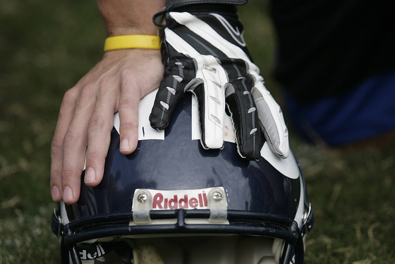 Knott County Central High School senior quarterback Braxton Ratliff and senior wide receiver Kenny Craft support themselves on helmet while listening to their coach after practice on Thursday, Sept. 17, 2009.