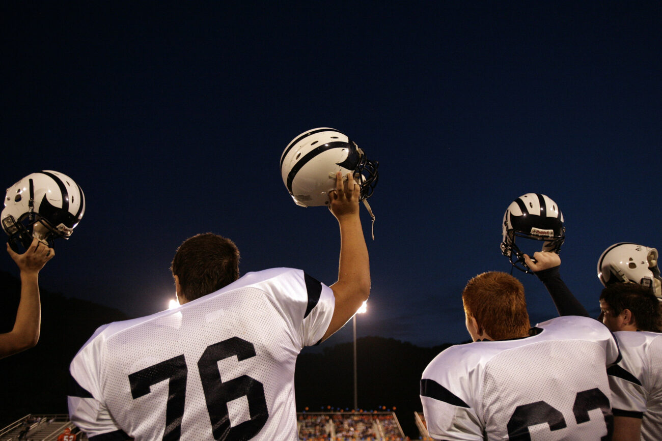 Sophomore offensive lineman Jonathan Green raises his helmet with his teammates as Knott County Central gets set to receive a kickoff during its game against Pike County Central on Friday, Sept 18, 2009.