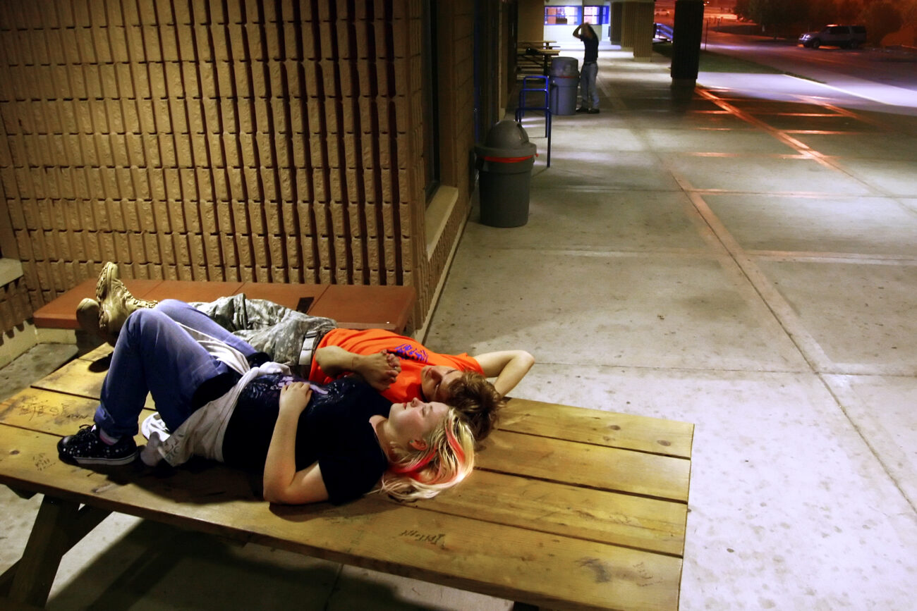 Dylan Parks, 14, and his girlfriend of nine months Angelica Moore, 15, cuddle in private on top of a pick-nick table outside of Pike County Central High School after the football game. ..
