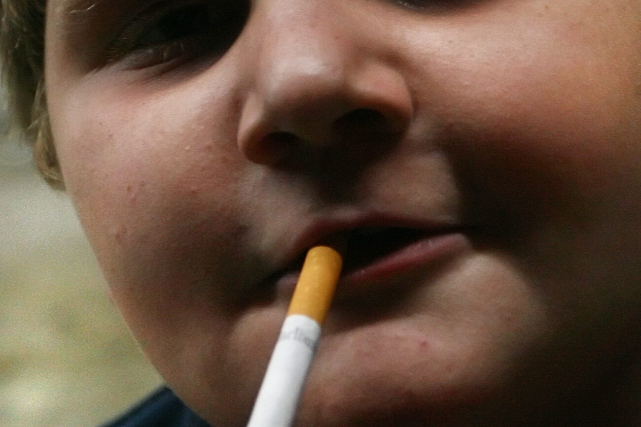 William Slone, 11, smokes a cigarette outside of the Mi-Dee Mart in downtown Hindman, KY. "It's already lit so I might as well," Slone responds when his mother scolds him for smoking.