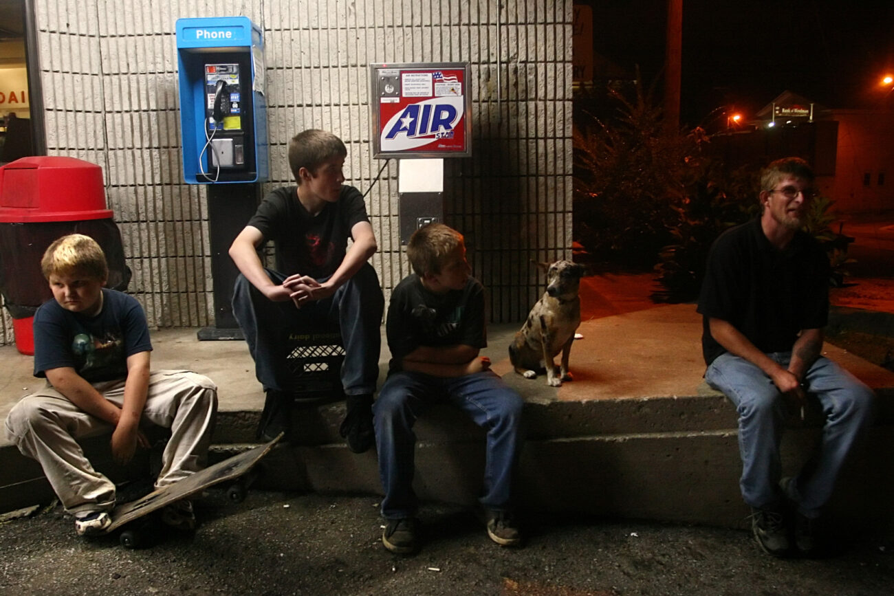 William Slone, 11, Joseph Short, 13, Johnthan Everage, 11, and Anthony Slone, 31, sit outside the Mi-Dee Mart after midnight in downtown Hindman, KY. "There isn't much to do in Hindman," says Short.