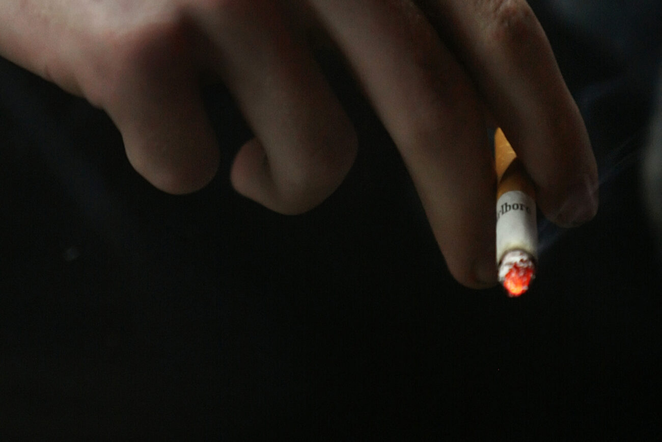 Joseph Short, 13, smokes a cigarette outside the Mi-Dee Mart after midnight in downtown Hindman, KY. The scars on his hand are the aftermath of a car accident in which Short lost his spleen.
