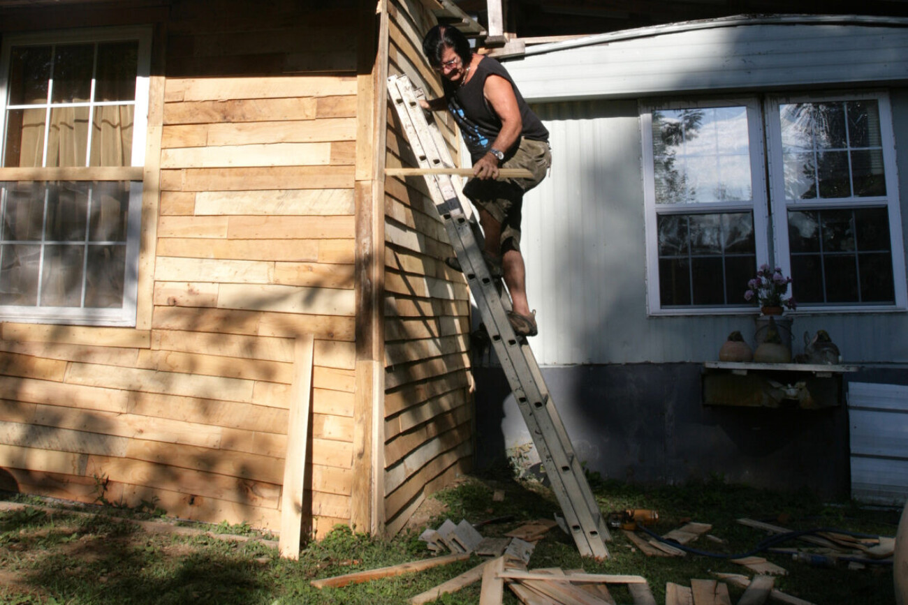 After working a variety of professions, ranging from jailer to custodian, an unemployed Charles Hobbs uses his free time to put siding on his new home in Beattyville Kentucky on Sept. 30, 2010. Photo by Matt Murray