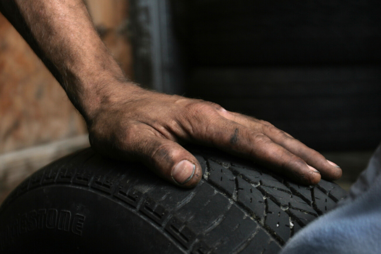 Branden Tirey rests after a long day of work at H&H Tires on Oct. 1, 2010. Photo by Matt Murray