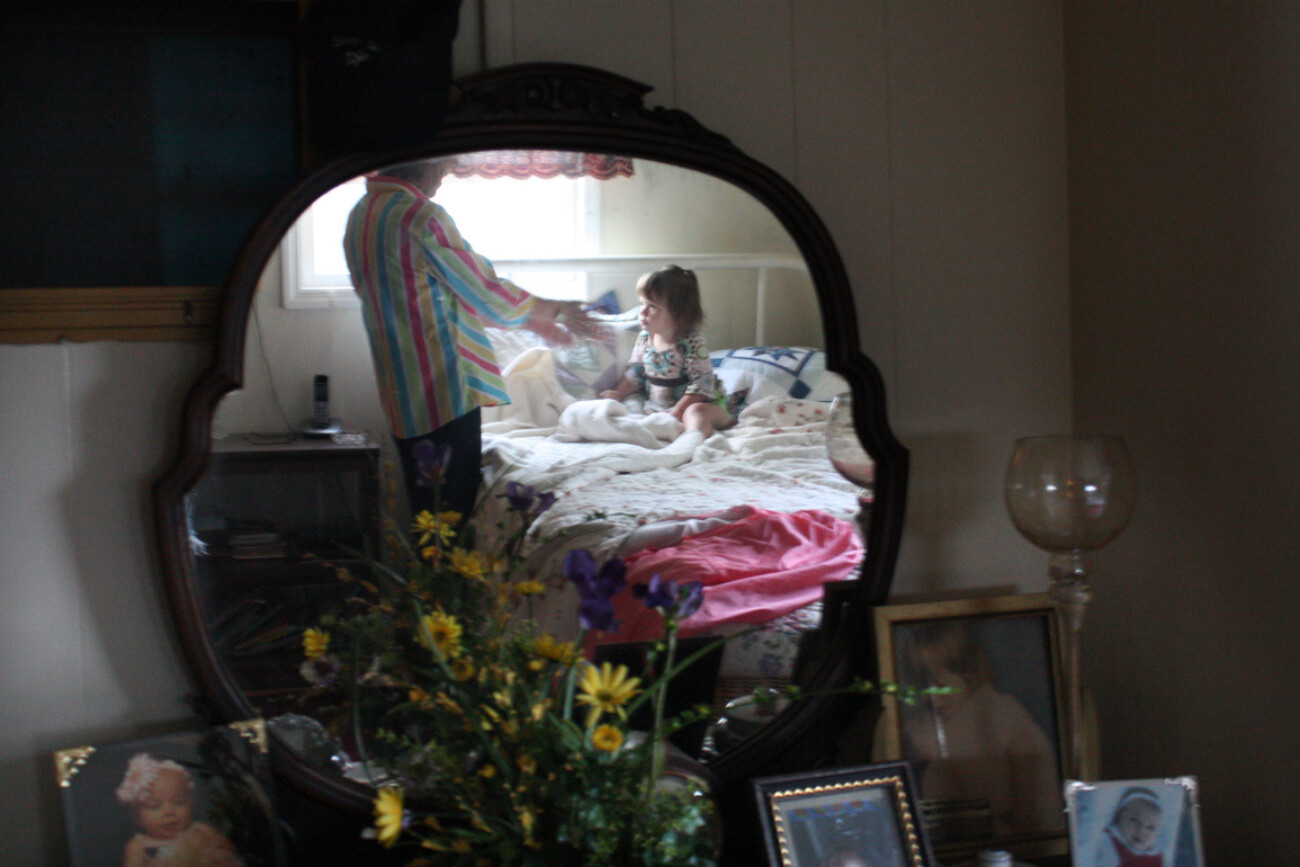 Nina Million wakes up her great-granddaughter, Kelli Million, for day care. Million adopted Kelli when drugs were found in her system at birth causing the mother to lose custody. Photo by Grace Profancik