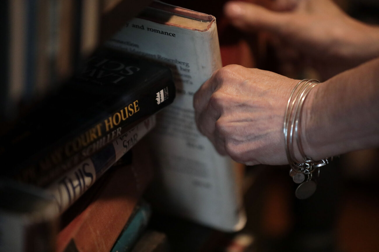 Lizz Taylor organizes books alphabetically in Poor Richard’s Attic in Frankfort, Kentucky, on Thursday, Oct. 14, 2021.