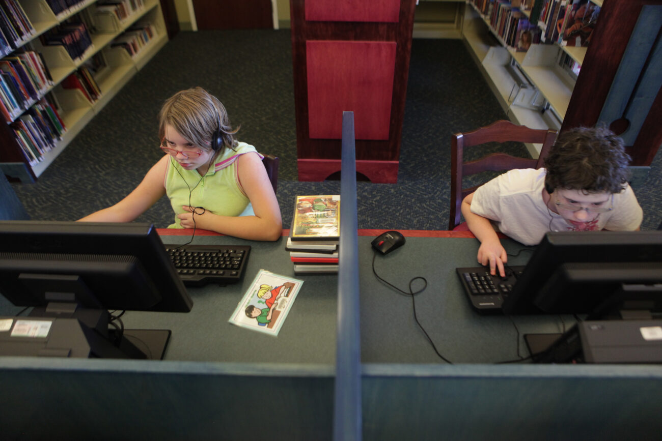 Sisters Christina (left), 11, and Marylynne Hall, 13, work on computers at the Laurel County Public Library in London, KY. Along with their father Joseph, the Halls have been staying at the Christian Homeless shelter for two and a half months. The girls are both avid readers and spend time at the library playing educational games and choosing books.