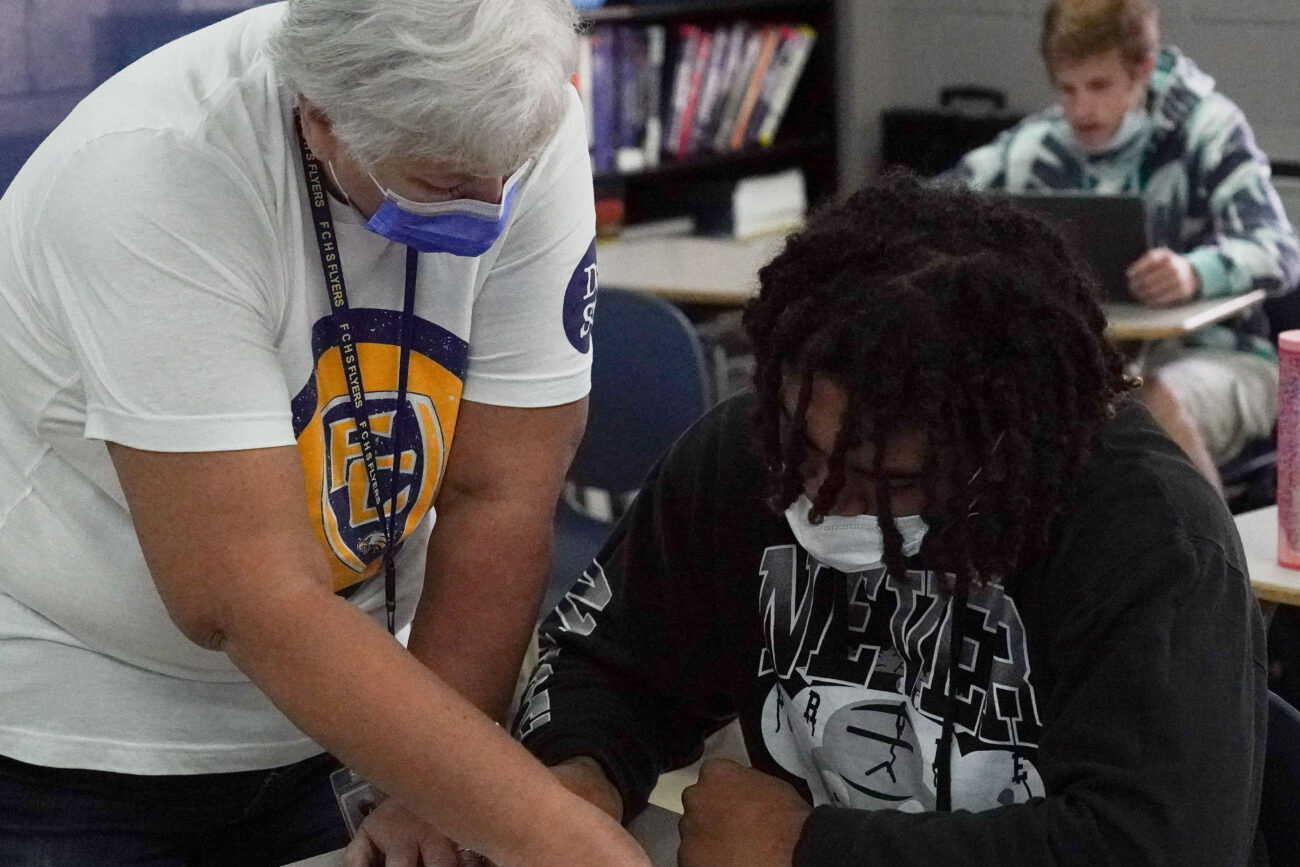 Math teacher Rebecca Kerhli helps Kaden Moorman with an in class assignment in Frankfort, Kentucky, Thursday, Oct. 14, 2021.