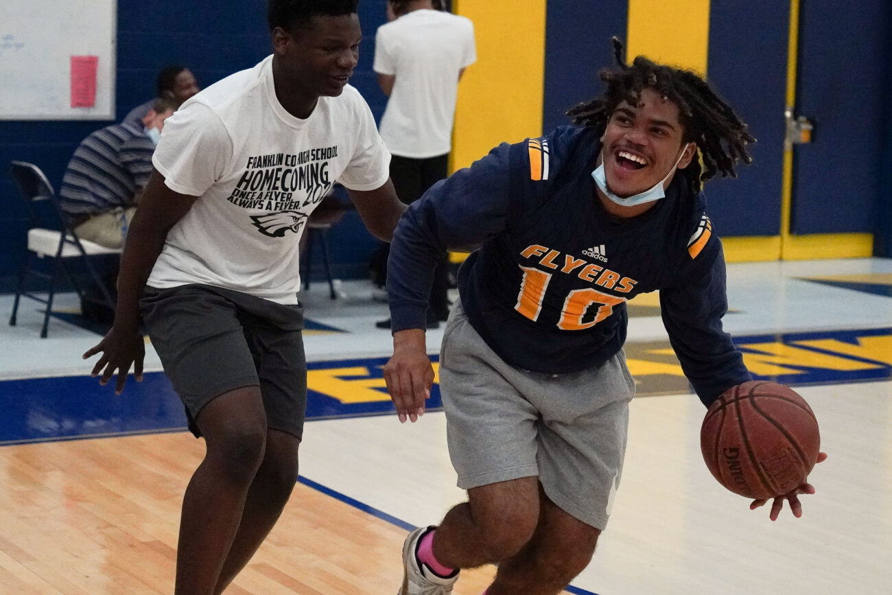 Kaden Moorman grins as he plays a game of basketball with his friend Jakob Pollard during fifth period in Frankfort, Kentucky, Friday, Oct. 15, 2021.