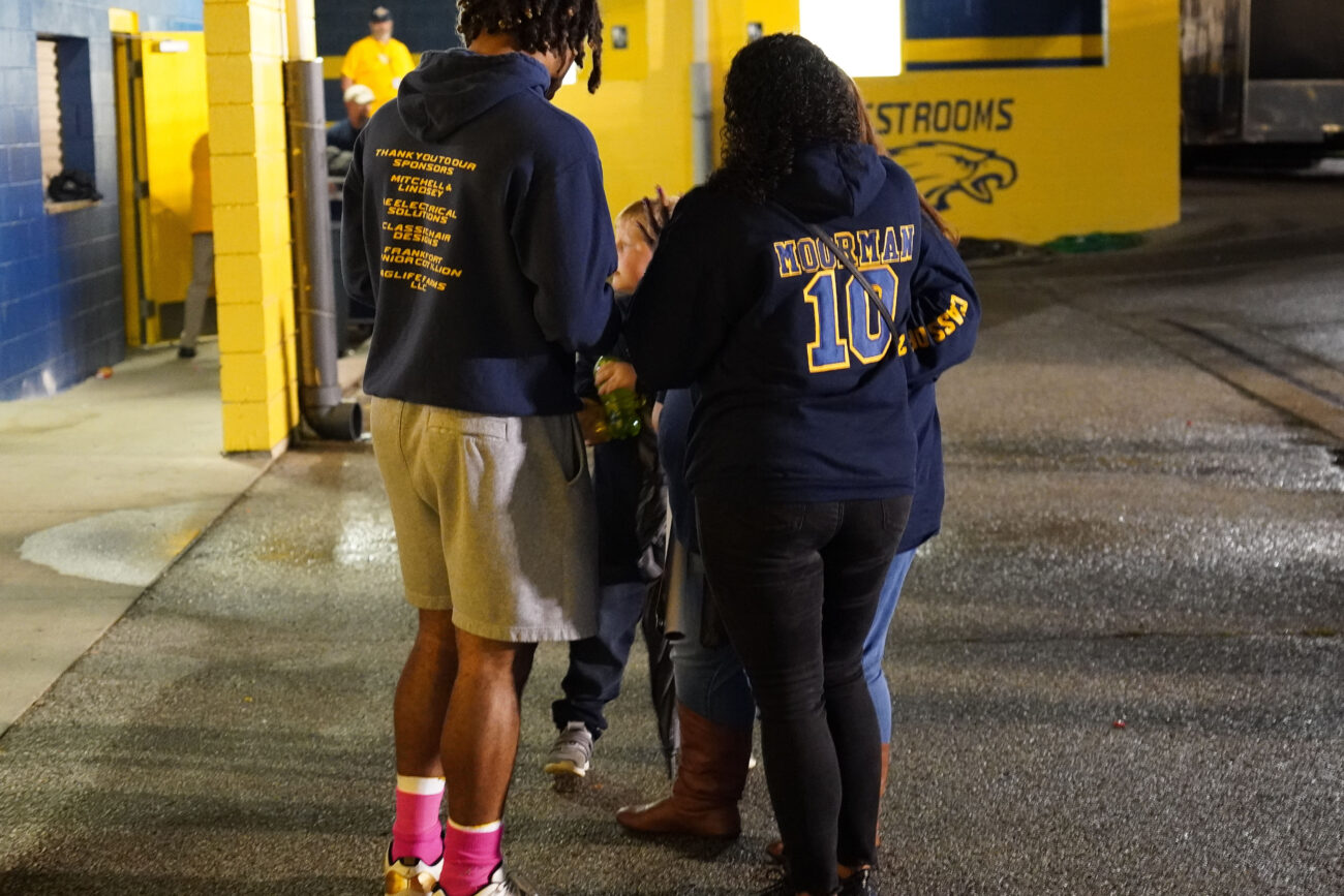 After his homecoming football game, Kaden Moorman walks with his mother, Whitney Washington, in Frankfort, Kentucky, Friday, Oct. 15, 2021.