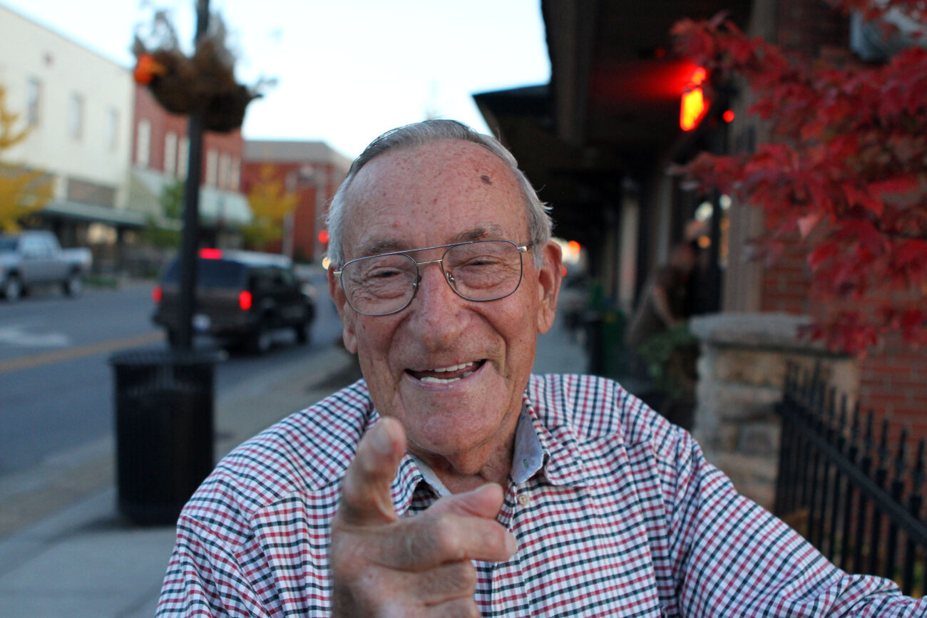 Herman Holmes smiles while he points down main street toward where the old movie theater used to be. Photo by Alex Holt