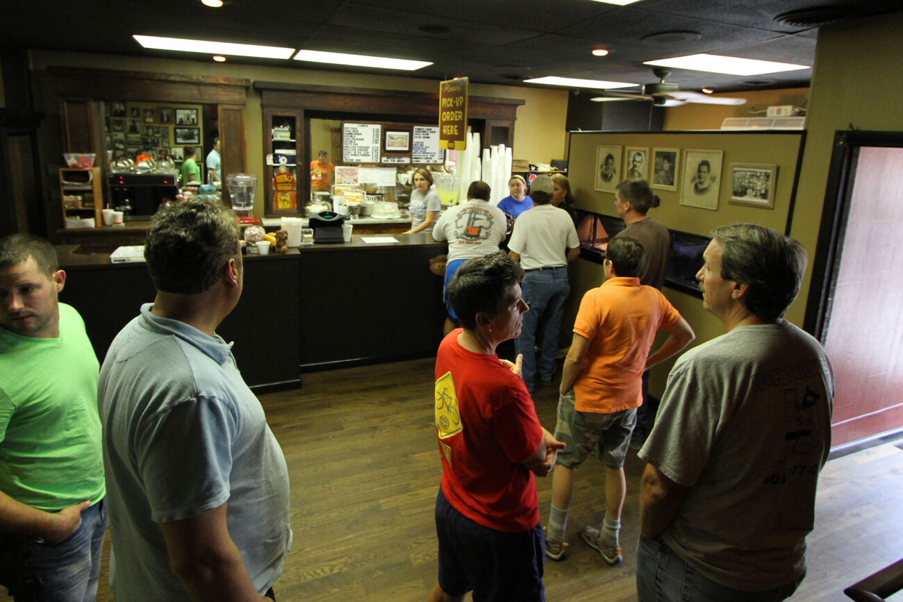 Long-time employee Nicky Parker inspects the scene as a line starts to form during the daily lunch rush. Photo by Alex Holt