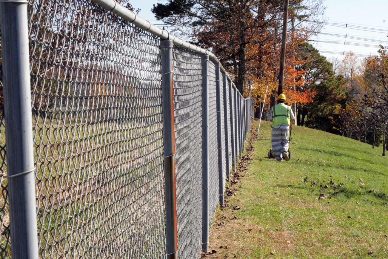 Donny Powers mows the grass outside the entrance of the Laurel-London Optimist club, a nonprofit activity center for children. "It's all for the children," Powers said. He was in jail because of a circumstance involving drugs, and will be released on Nov. 1. .Photo by Amanda Powell