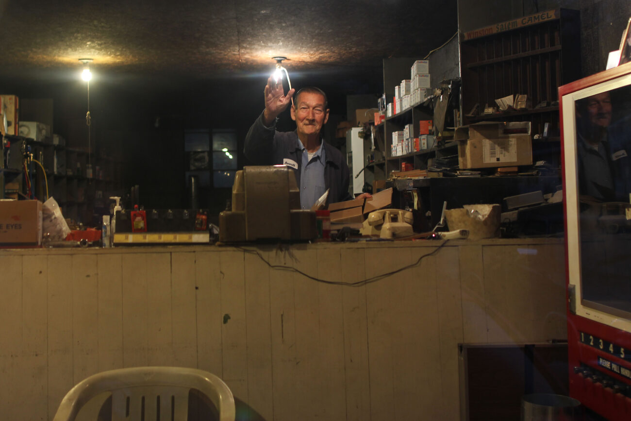 Bonnell Bentley waves from inside his shop Bentley's Repair Service. Photo by Judah Taylor