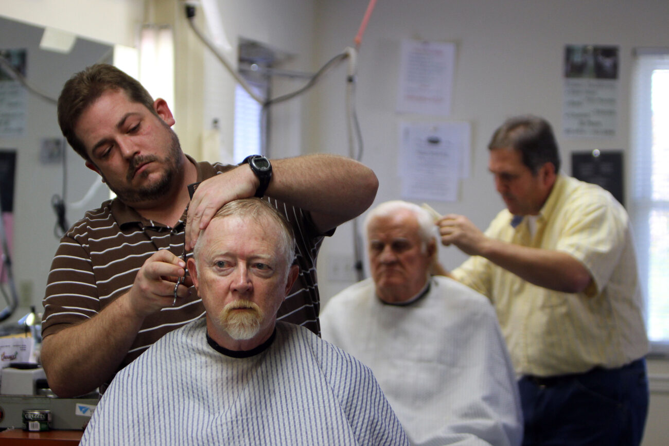 Greg Anderson cuts a customer's hair. Anderson has been working with Jim for about 14 years. He went to barber school with another barber, Dwayne, who introduced him to Jim Cloud. Photo taken at Jim Cloud Barbershop in London, Ky. on October 25, 2012. Photo by Quianna Lige