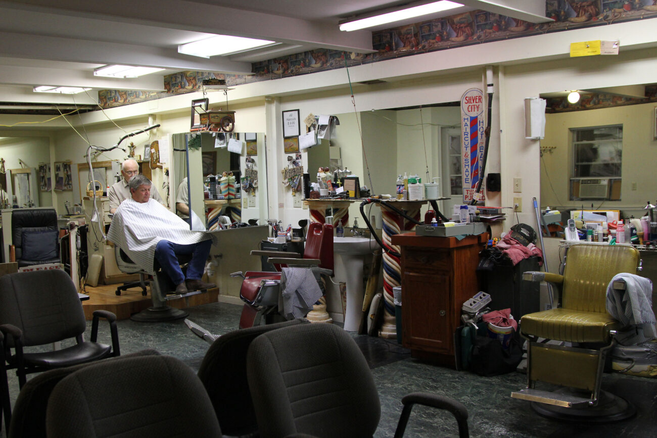 Jim Cloud cuts a customer's hair at 6:30 in the morning. Though the shop doesn't open until 7 a.m., Cloud gets to work at 6:30 and takes any customers that comes early. "He's a good guy, he's a strong believer. He's always been a friend," Bob, a long-time friend of Jim, said. "It's called loyalty. Jim made me feel like i was important." Photo taken at Jim Cloud Barbershop in London, Ky. on October 26, 2012. Photo by Quianna Lige