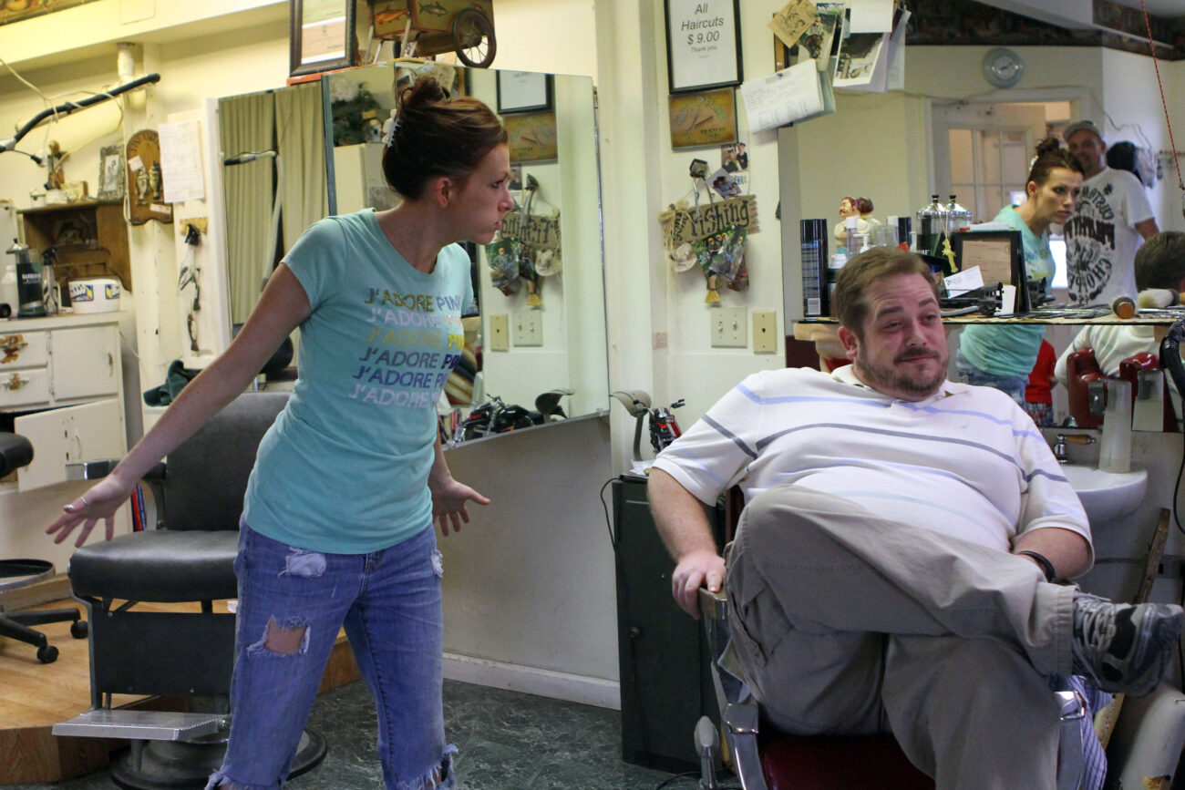 Greg Anderson jokes around with a customer who says that he should have a picture of her son, Caleb, hanging up at Jim Cloud Barbershop in London, Ky. on October 26, 2012. Photo by Quianna Lige