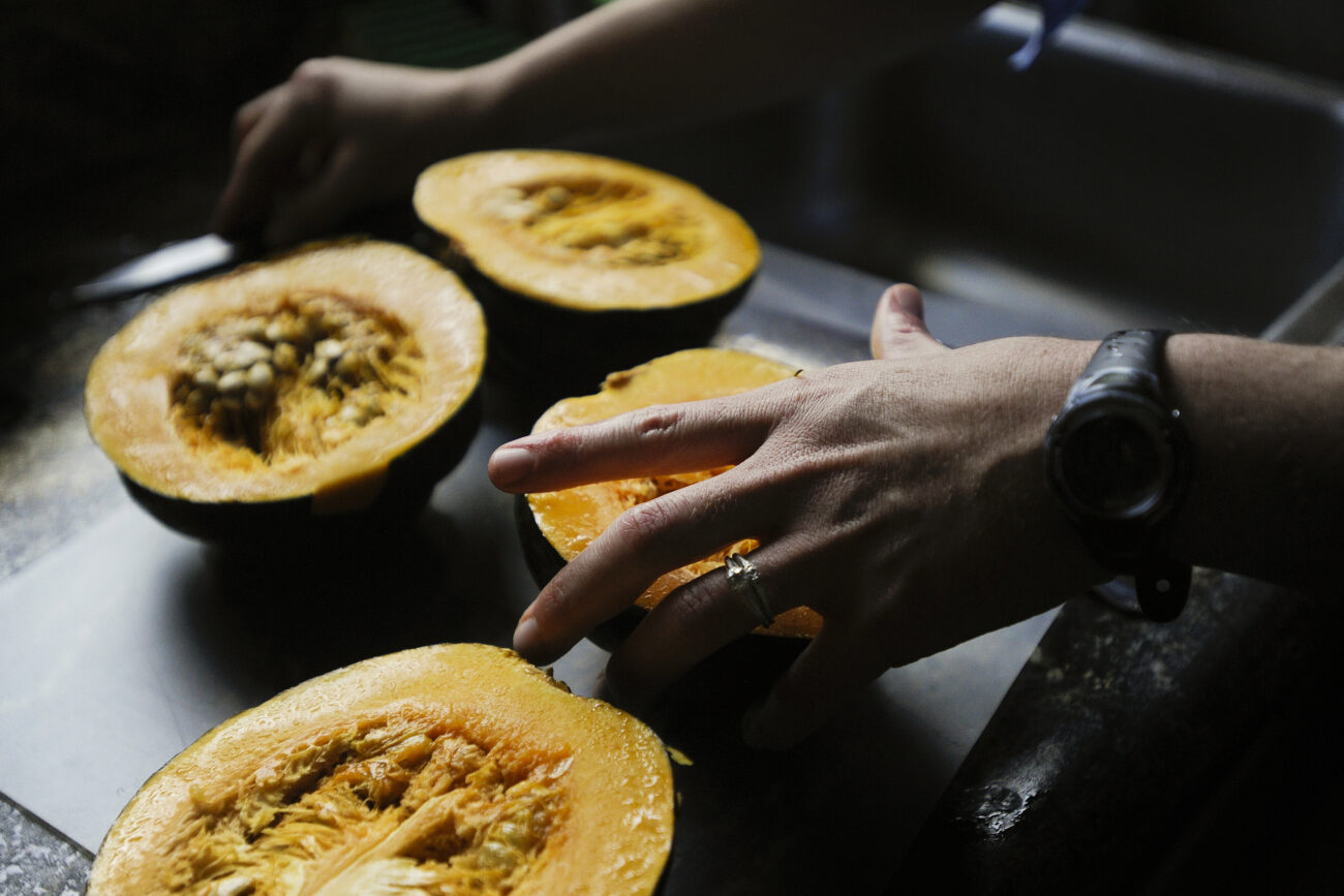 Amanda Waterstrat cuts her organic acorn squash in slices to bake for dinner. The Waterstrats grew the squash themselves, along with some of the other vegetables and meat prepared for the meal.