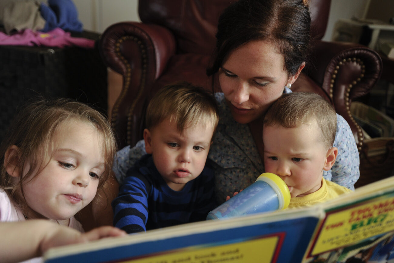 Amanda Waterstrat reads a "Thomas the Engine" book with Allie Horn, 4, Noah Horn, 2, and her son Finley, 2, after they wake up from a midday nap. Amanda and Ford Waterstrat said they want to have more children, but need more space for the bigger family. They are currently building an addition to the house to make that happen.