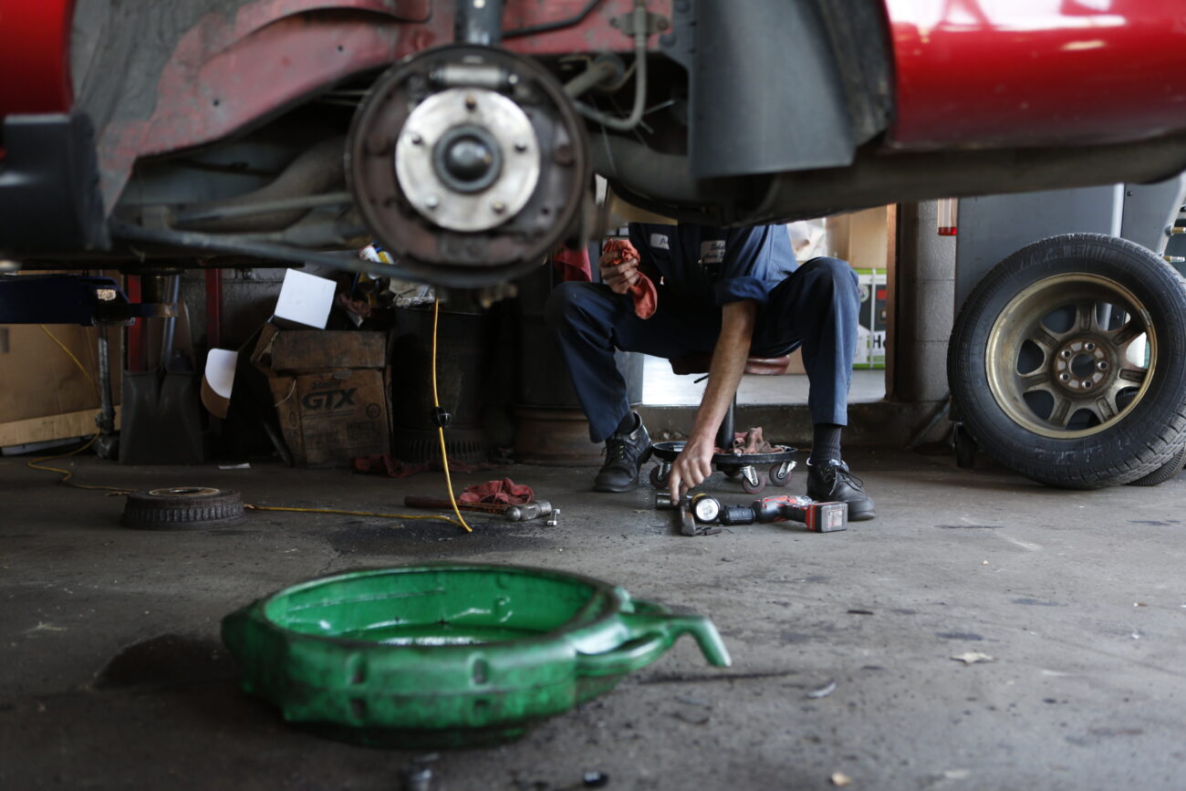 Jim Schott changes the brakes on a customer's car on October 25, 2012. Jim, Roy's nephew, has been working at Schott's since high school. Jim would take the bus straight to the shop after school. ..Photo by Coty J. Giannelli