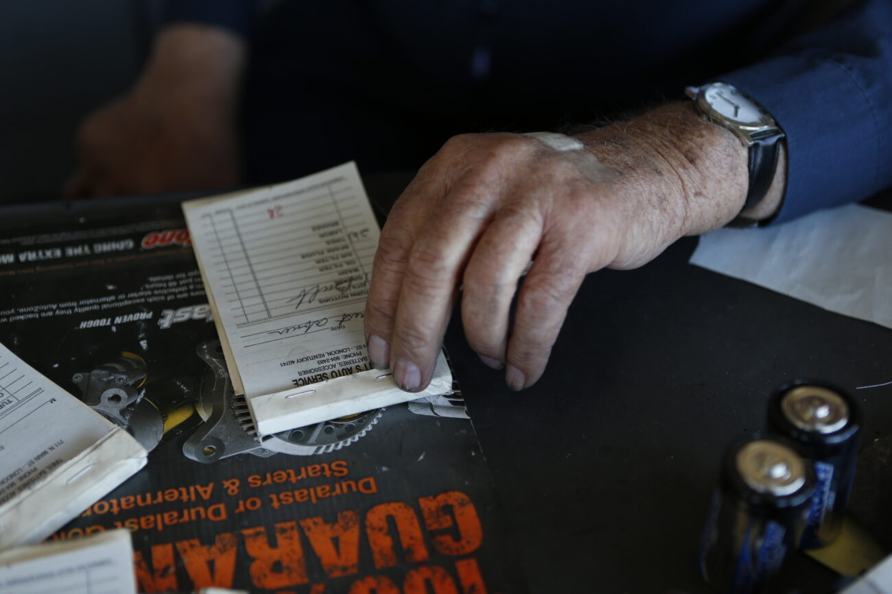 Roy writes out a customer's bill on October 25, 2012. Other than replacing one of his lifts, Roy's shop is almost the same as it was in 1964. ..Photo by Coty J. Giannelli