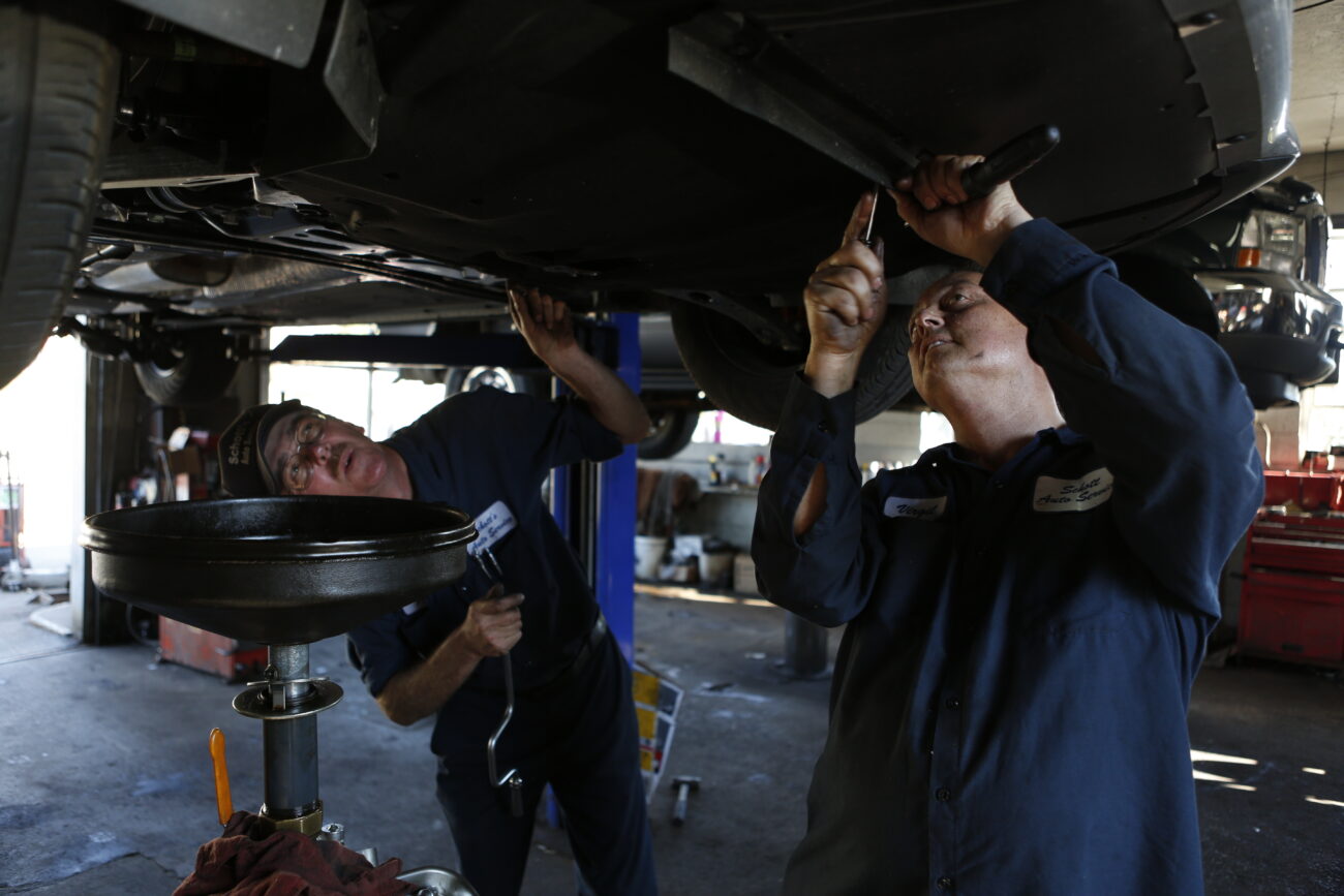 Jim and Virgil McWhorter, 48, start to change the oil on a customer's car on October 25, 2012. ..Photo by Coty J. Giannelli