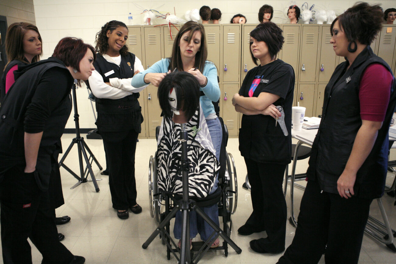 Brandy Brock demonstrates a hair-cutting technique on a mannequin for her students at Somerset Community College in London, Ky., on Thursday, Oct. 25, 2012. "It's nice that I can stand up in front of the class in the morning," Brock said. Photo by Tessa Lighty