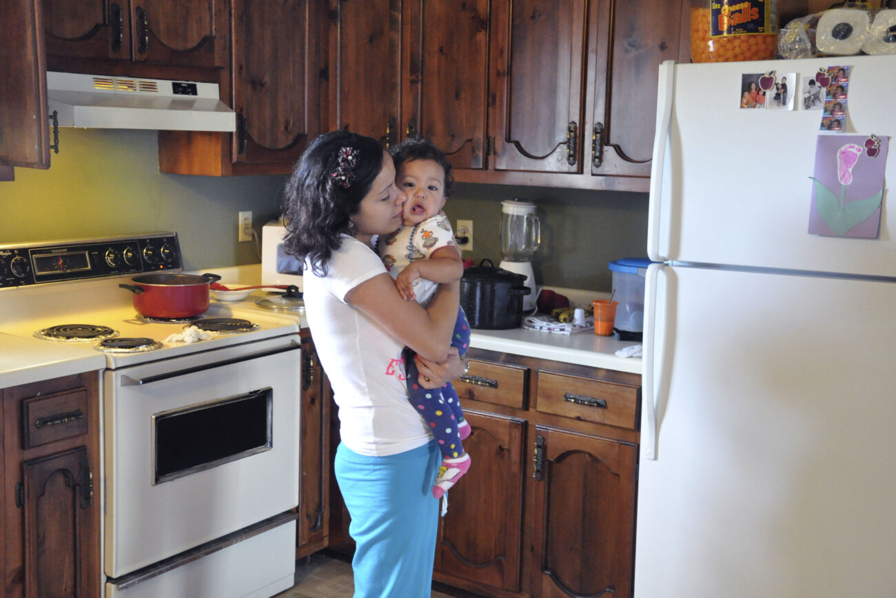 Mimi Ocampo dances with her younger daughter, Meli, in the kitchen of her apartment in London, Ky., after lunch on Friday, Oct. 26, 2012. Ocampo speaks in Spanish with her children and sings them songs by Spanish artists, like Enrique Iglesias. When she still lived in Oaxaca, Mexico, she would go to parties and dance every weekend, Ocampo said. | Photo by Taylor Moak