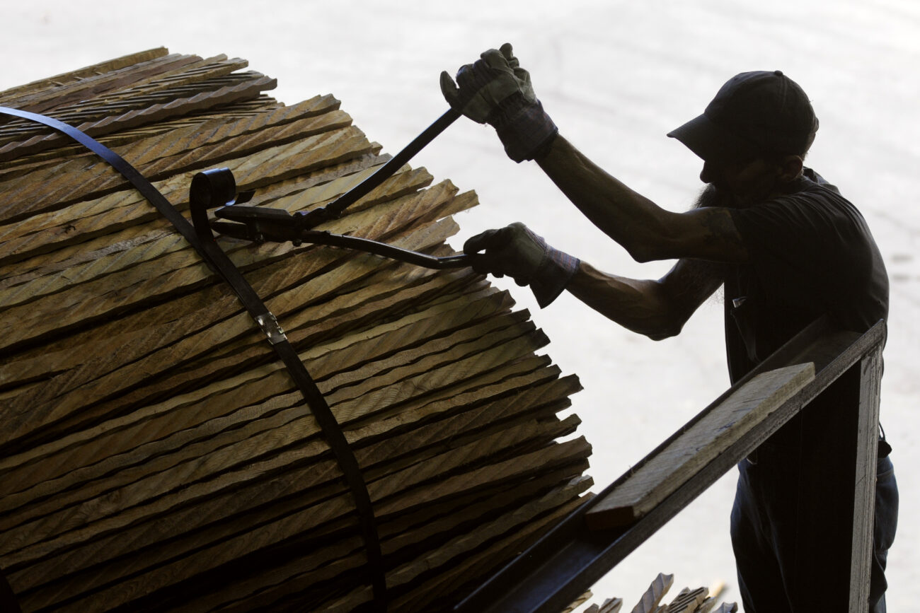 Ronnie "Bin Laden" Jones, 53, cuts the ties on a pack of "sticks," small pieces of scrap wood used to separate layers of green wood so it dries properly in the open air, then in a special lumber kiln.