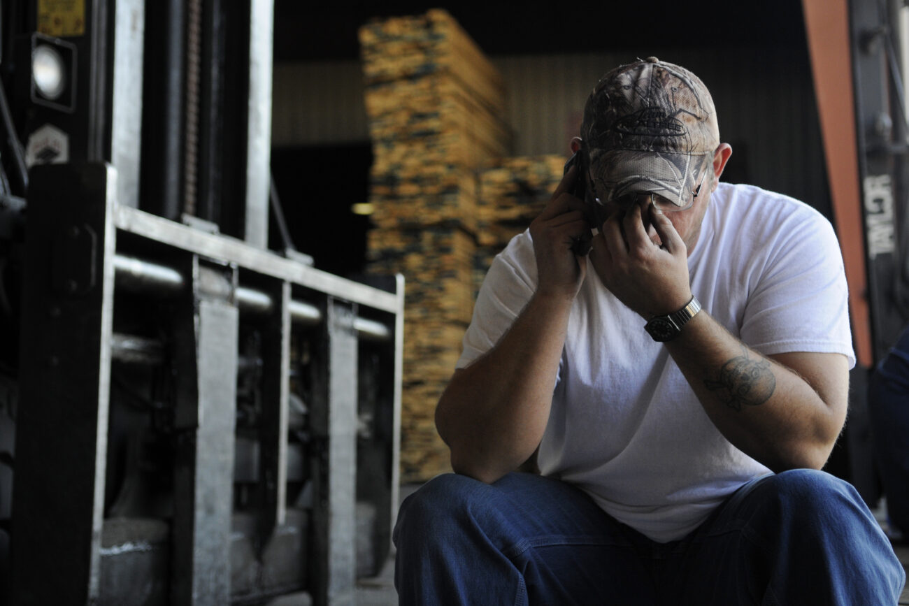 Richard "Strawberry" Smith, 36, rubs his eyes and speaks with his fiancée about wedding details during the final break of his 10-hour work day at Begley Lumber Thursday afternoon. Strawberry and his fiancée were married three days later.