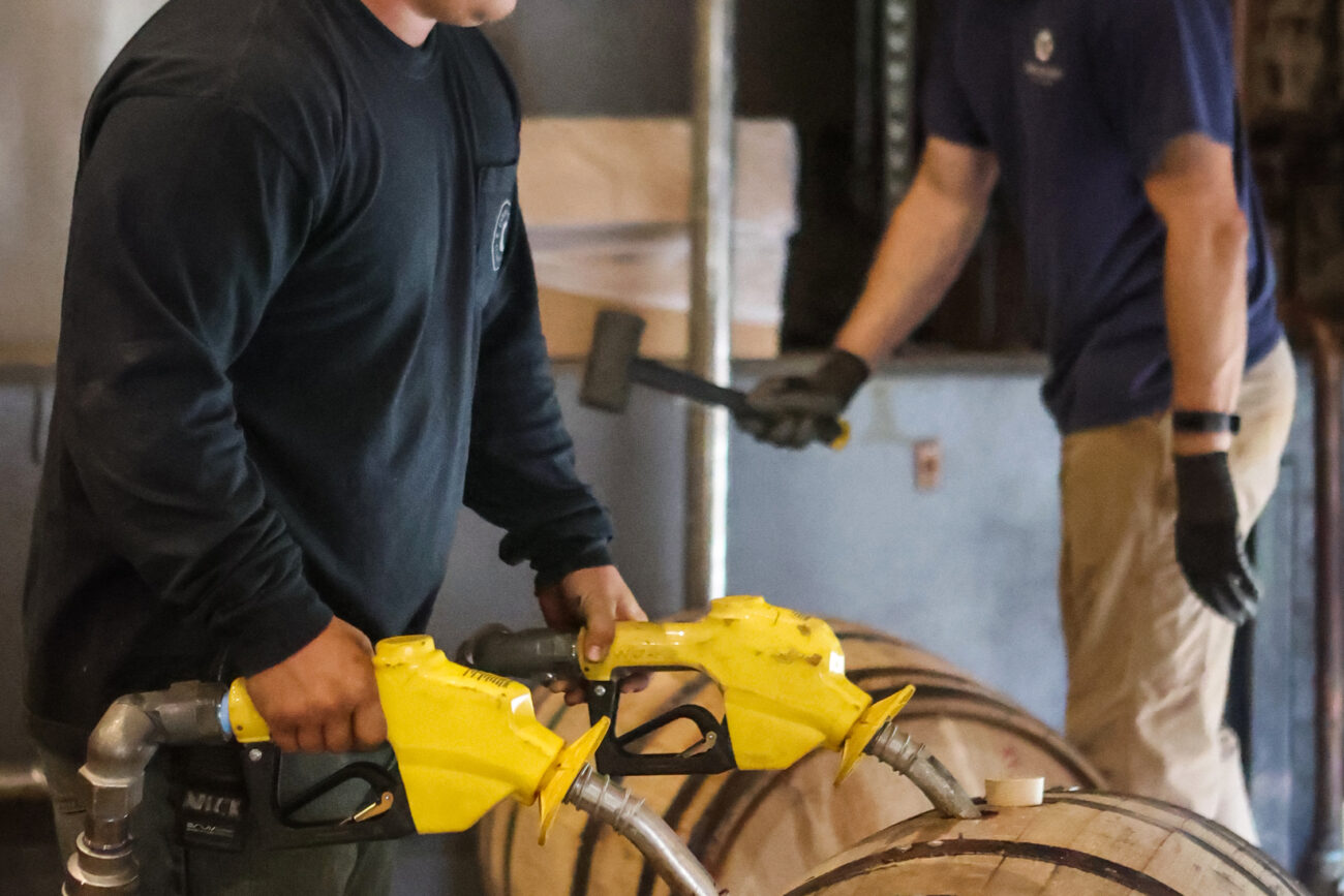 Warehousemen Nick Cutter and Jake Goodwin fill barrels at Castle & Key Distillery on Friday, October 15, 2021, in Frankfort, KY.