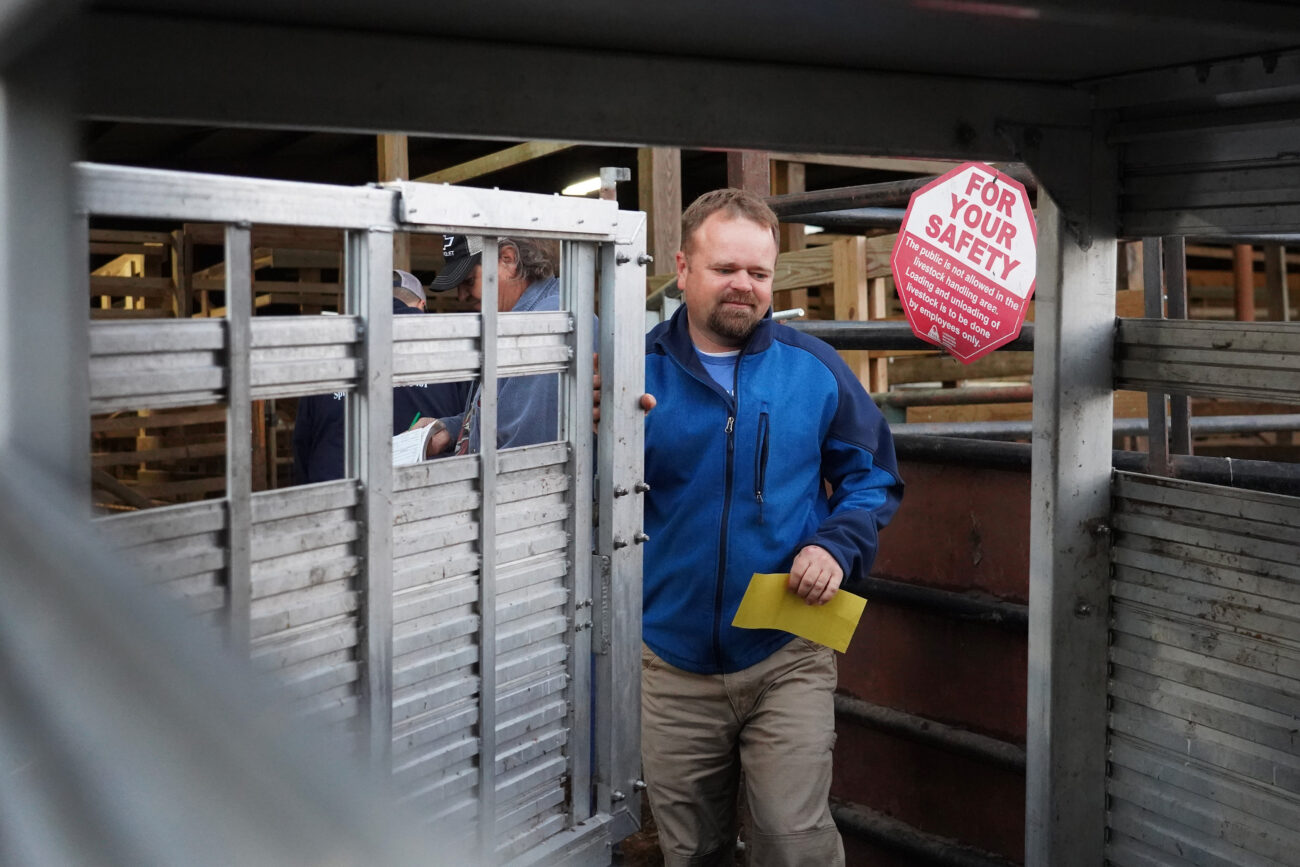 After having just sold one of his show lambs to a stockyard after taking it to shows in the summer J.R. closes the door to the trailer embellished with the name of his business on it on Saturday, Oct. 16, 2021, in Frankfort, Ky. Photo by Kaitlyn Skaggs