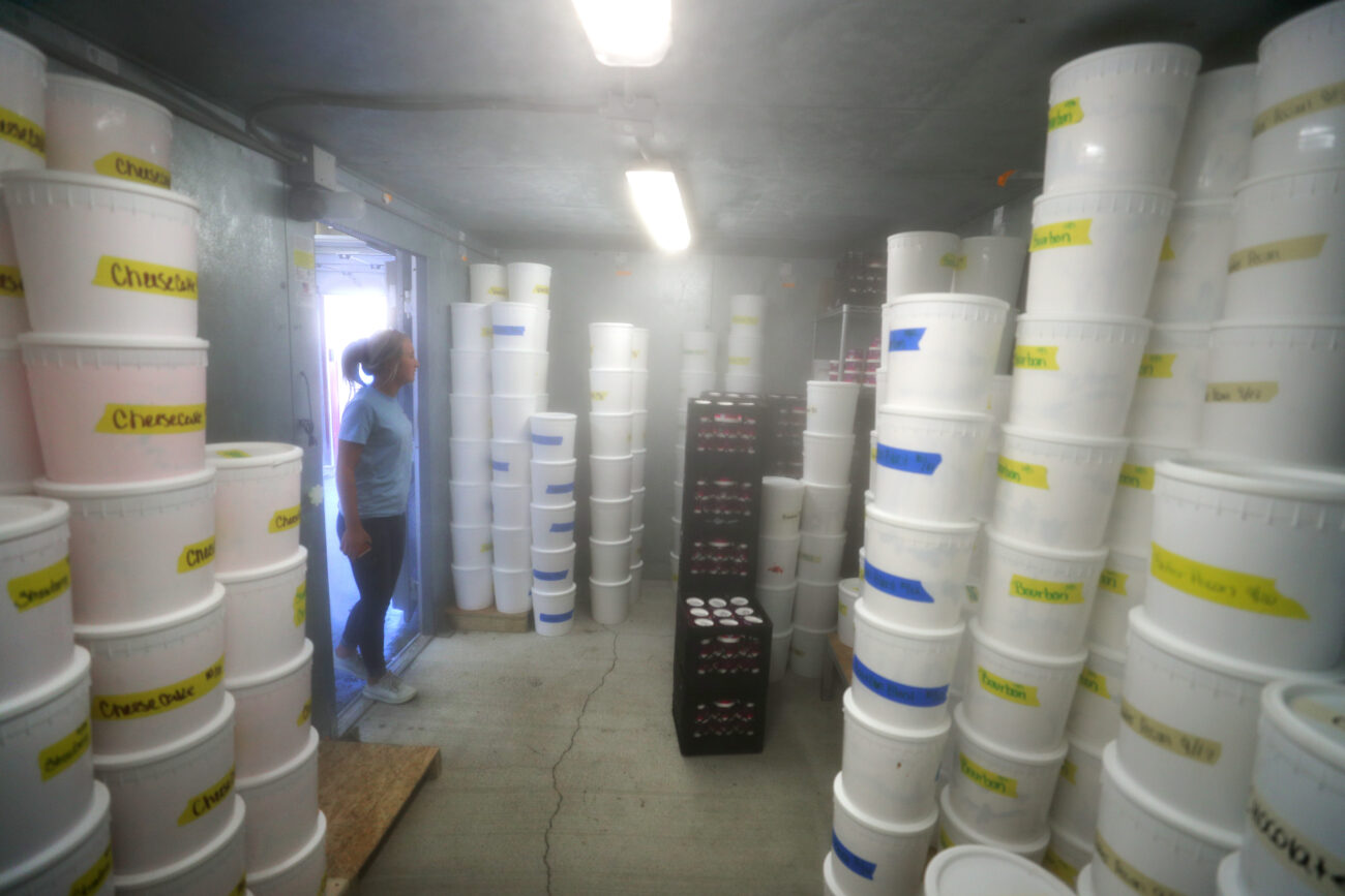Cook surveys her stock of ice cream in her main freezer at the production facility on Thursday, Oct. 14, 2021.