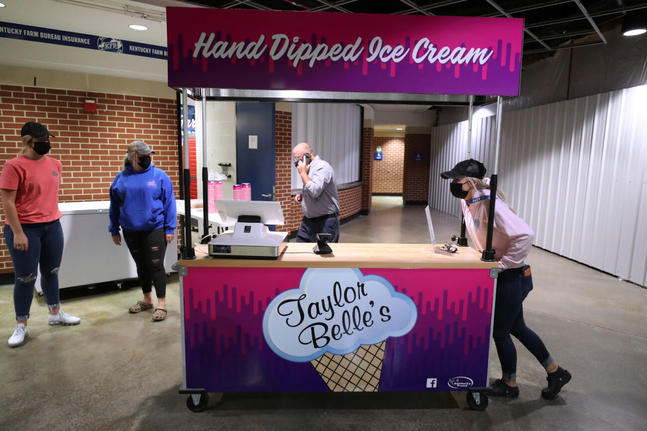 Cook (right) pushes a Taylor Belles cart into position ahead of Big Blue Madness at Rupp Arena on Friday, Oct. 15, 2021, in Lexington, Kentucky.