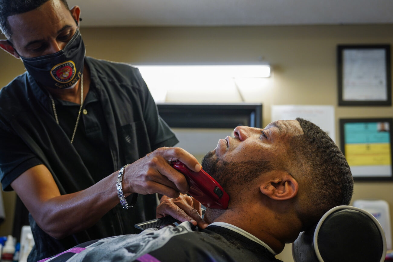 Ricky Redden lays in the barber chair while Moe Shands shaves his beard on Thursday, Oct. 14, 2021 in Frankfort, Kentucky.