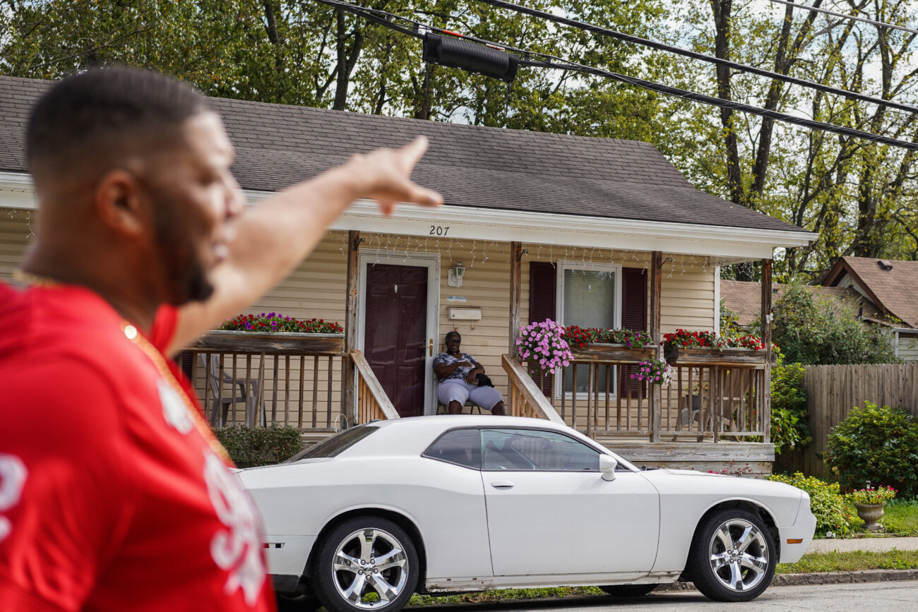 Ricky Redden waves at a neighbor while he walks through his childhood neighborhood in Frankfort, Kentucky, on Thursday, Oct. 14, 2021.