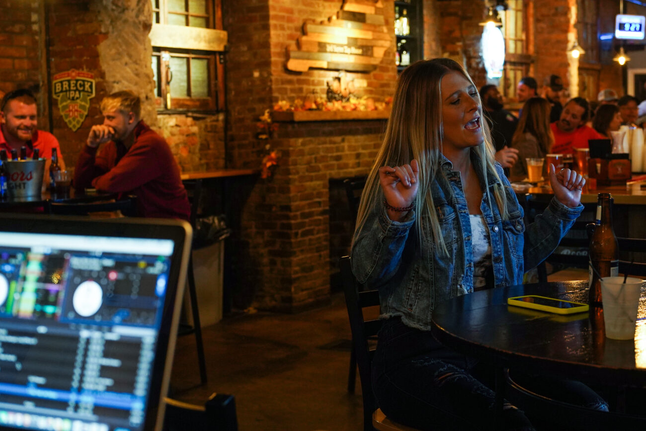 A bar patron dances to music DJed by Ricky Redden at 3rd Street Tap House in Bardstown, Kentucky, on Friday, Oct. 15, 2021.