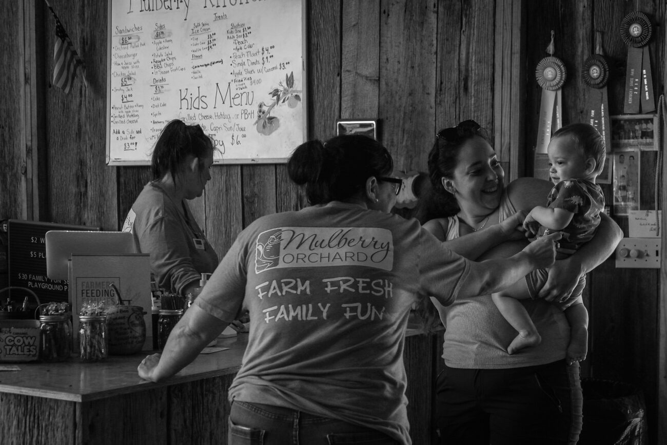 Employees at Mulberry Orchard eagerly greet Harrison Buckler, son of Emily Buckler in Shelbyville, Ky. on Thursday, Oct 14, 2021. Emily is a former employee at the orchard, and her lamb meat is now sold there.