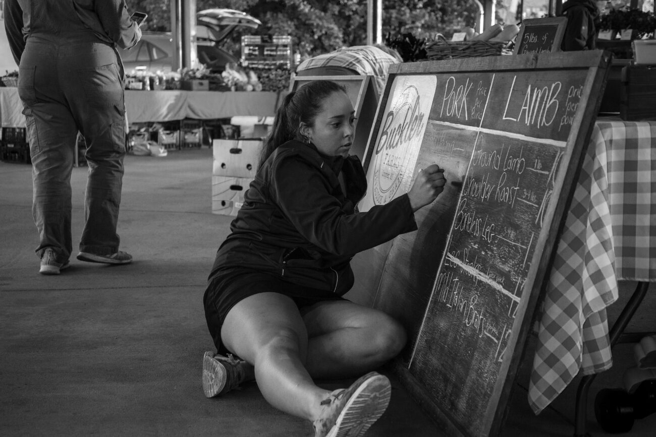 Owner Emily Buckler updates her sign with the meat selects for the weekend in Frankfort, Ky. on Saturday, Oct. 16, 2021 (Photo by Martha McHaney).