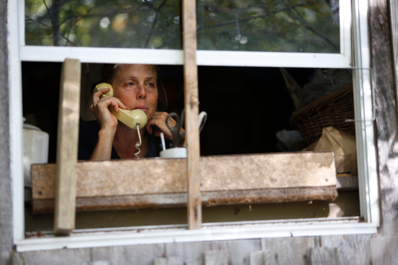 Chris Schimmoeller uses her landline phone to call JW Blackburn, the second district magistrate on the Franklin County Fiscal Court, to urge him to vote against a zoning change before a Fiscal Court meeting on Thursday, Oct. 14, 2021, at her home off of Mount Vernon Road in Frankfort, Kentucky. Schimmoeller, who lives off the grid, is the president of Envision Franklin County, a community organization intended to promote proper use of land in Franklin County. Photo by Jack Weaver