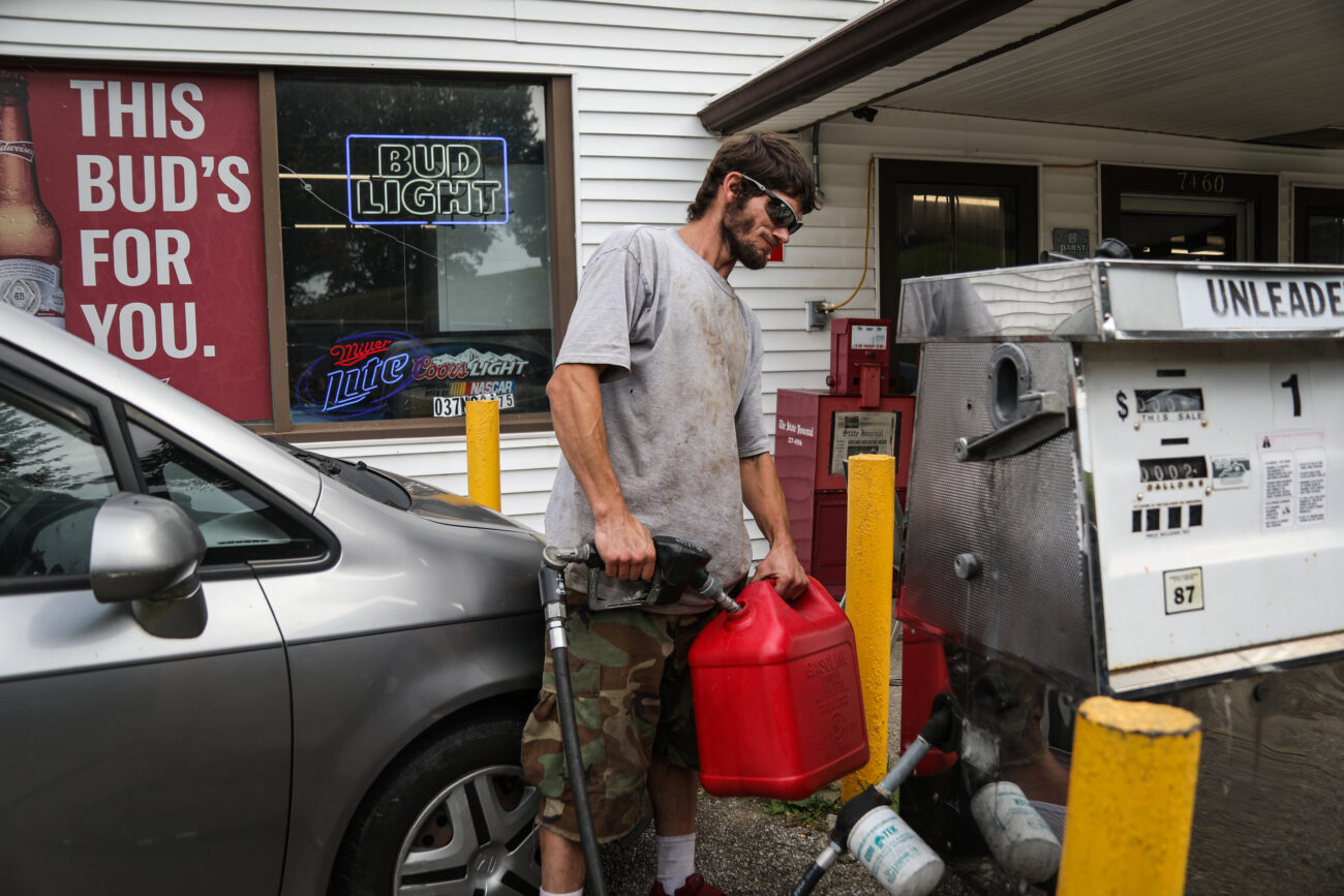Travis Brannon pumps gasoline to fill his moped at the Bald Knob Little Market in Frankfort, Ky. on Wednesday, Oct. 13, 2021 (Photo Martha McHaney).