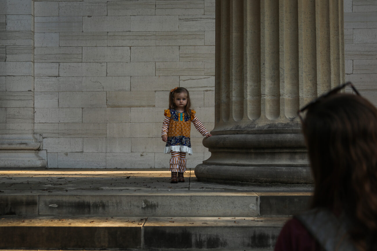 Daughter Emma poses for her mother, Casey Lilly, at the Old Kentucky State Capitol in Frankfort, Ky. on Thursday, Oct. 14, 2021 (Photo by Martha McHaney).