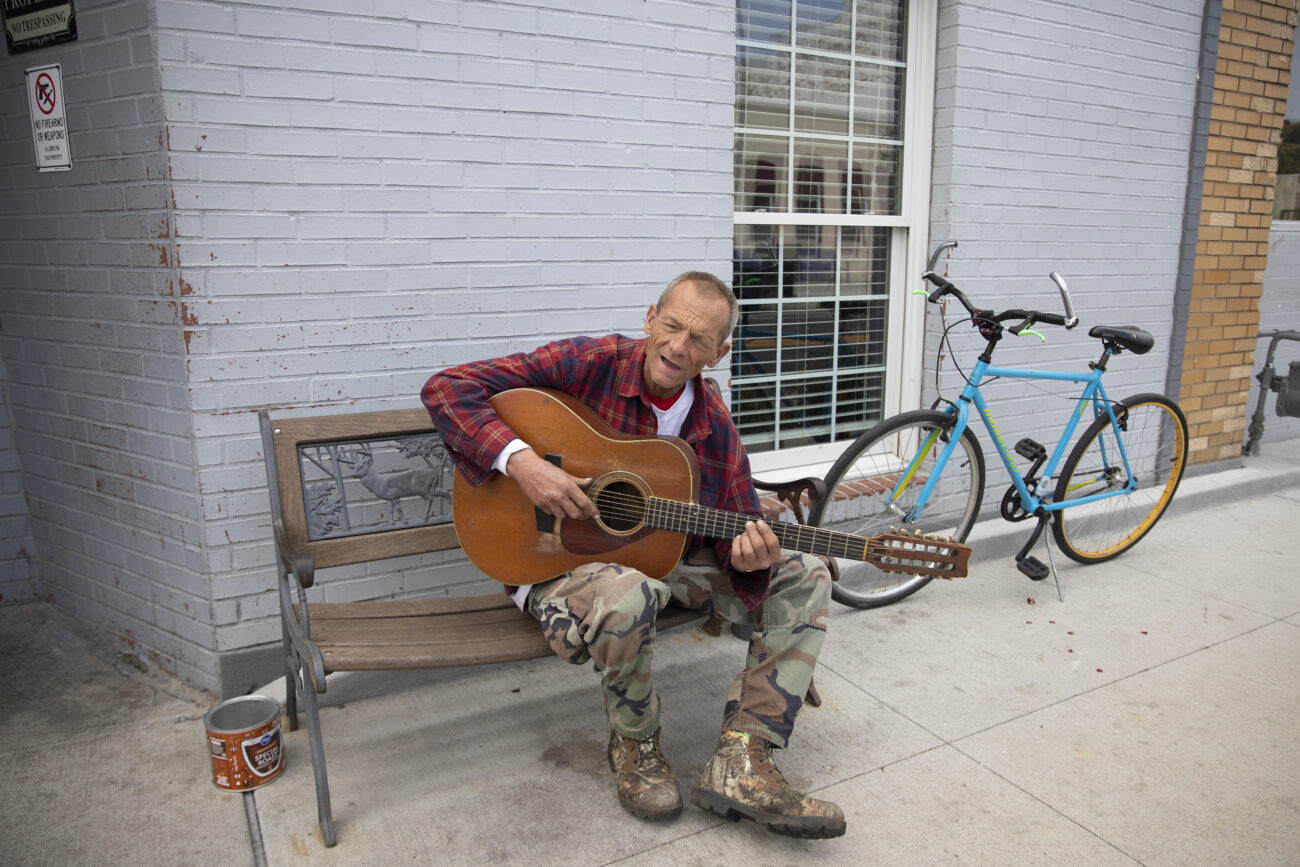 Will Wilburn plays guitar as he waits to go inside of ACCESS Men’s Shelter and Soup Kitchen in Frankfort, Kentucky on Friday, Oct. 7, 2022.