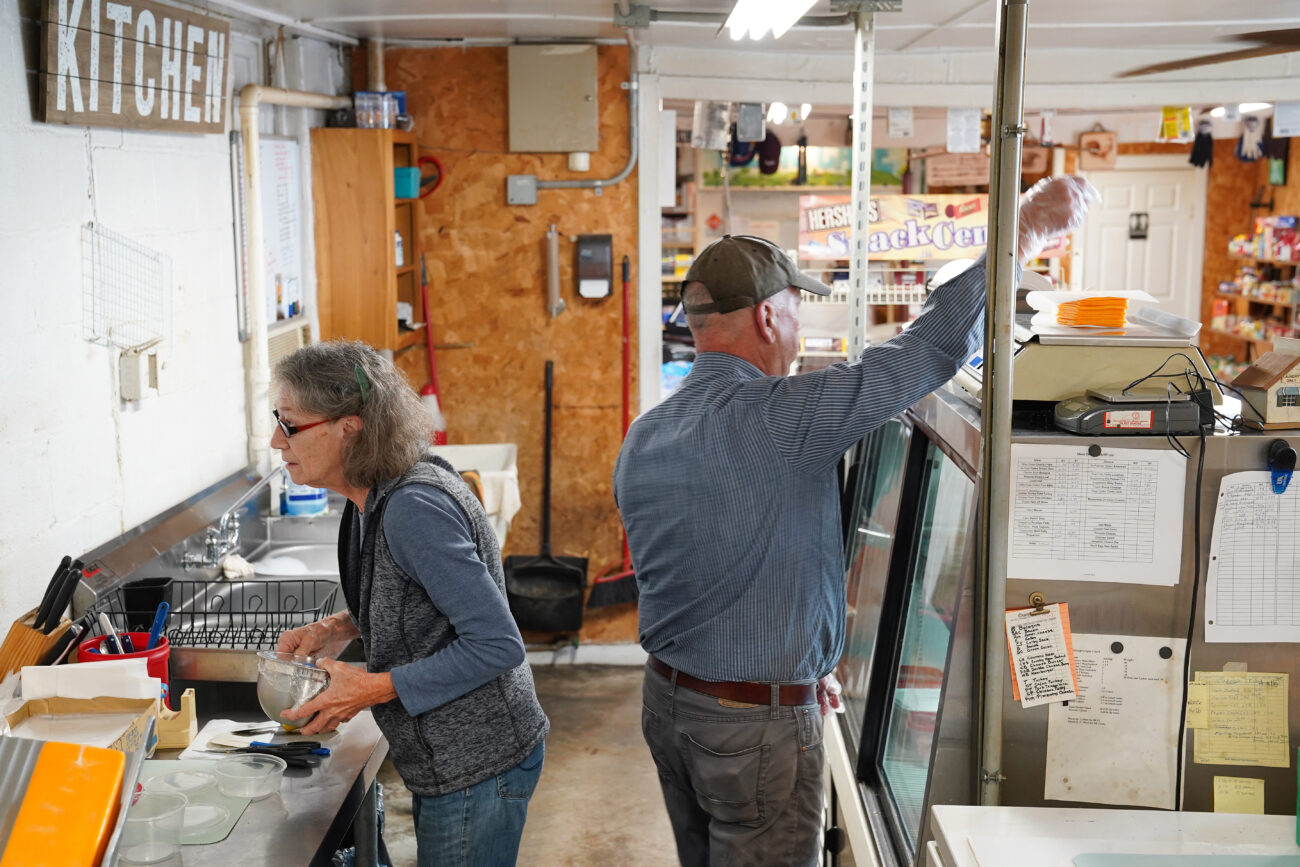 Store owners Dan Midkiff and Katie Clark work behind the deli counter at Bald Knob Little Market in Frankfort, Kentucky on Wednesday, Oct. 5, 2022. Photo by Bryce Towle.
